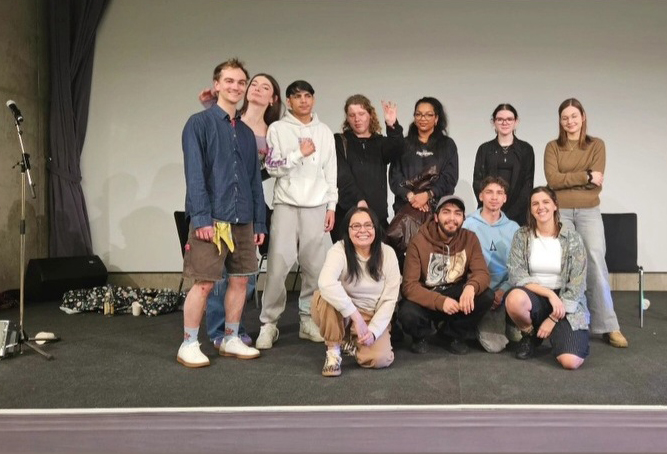 Jugendliche stehen gemeinsam mit Jugendarbeiter:innen des Jugendtreffs Arthaberbad auf der Bühne.